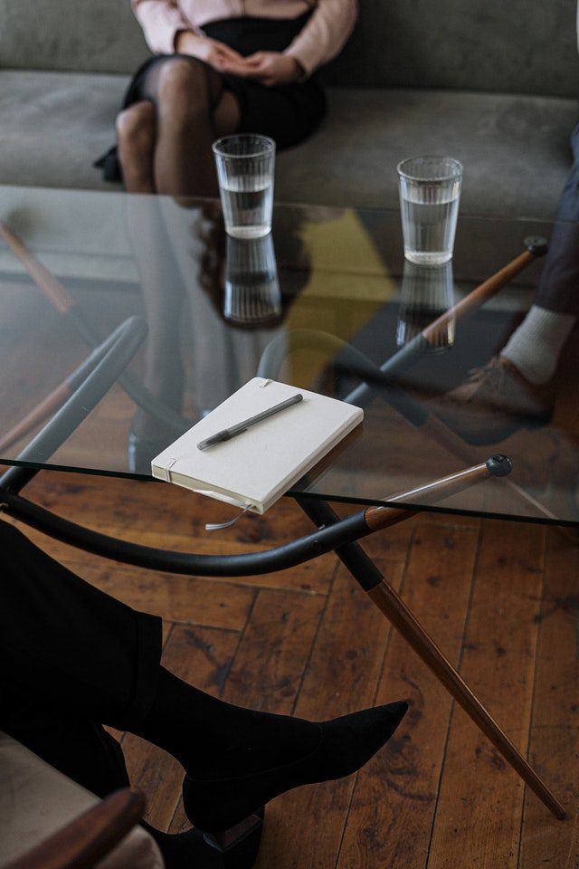 pexels-cottonbro-4098232 Woman in Black Long Sleeve Shirt Sitting on Brown Wooden Chair